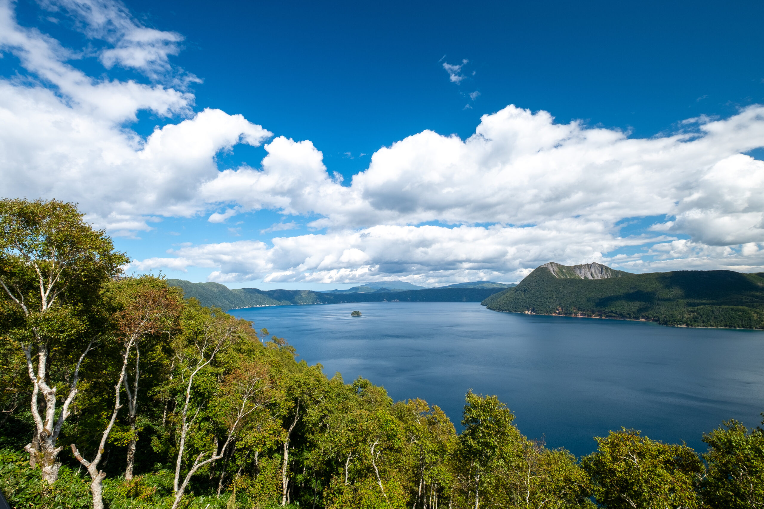青空のもと豊かな森と断崖に囲まれた神秘的なカルデラ湖である摩周湖の絶景